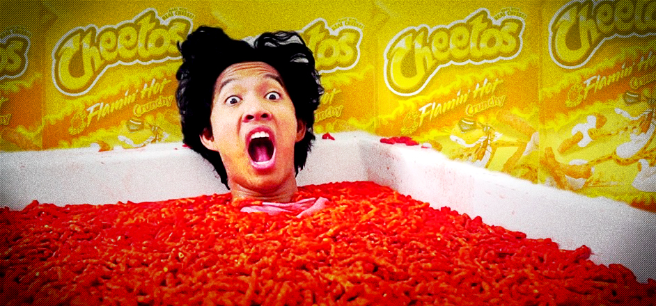 man eating cheetos in tub