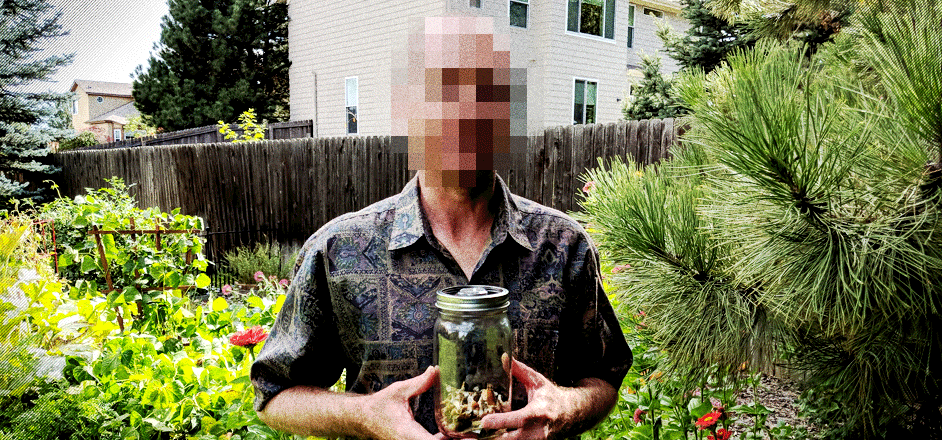 photo - man holds jar of psilocybin mushrooms he uses for his pain - photo by Reilly Capps Rooster Magazine